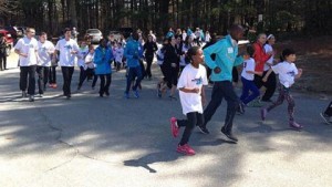 Elite Kenyan runners lead Elmwood students on a short run. (Photo by Sera Congi-WBZ-TV)
